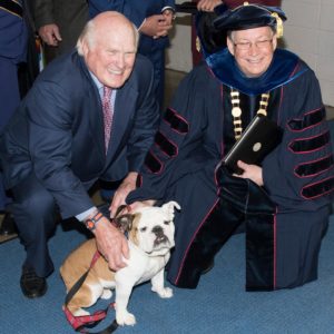 Terry Bradshaw and Dr. Guice pose with Tech XXII before the 2019 Spring Commencement.