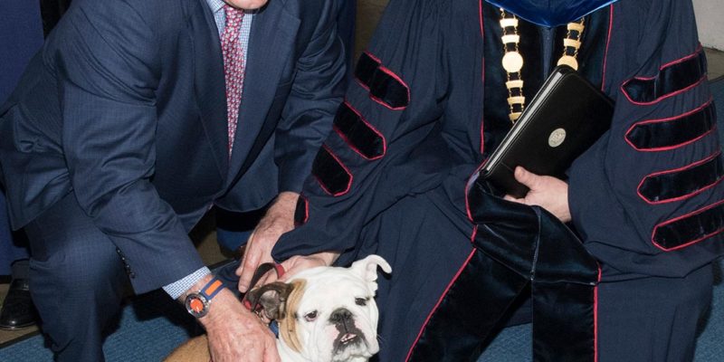 Terry Bradshaw and Dr. Guice pose with Tech XXII before the 2019 Spring Commencement.
