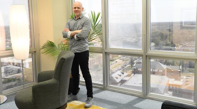 Emerson Oaks standing in Dr. Davy Norris' office in Wyly Tower.