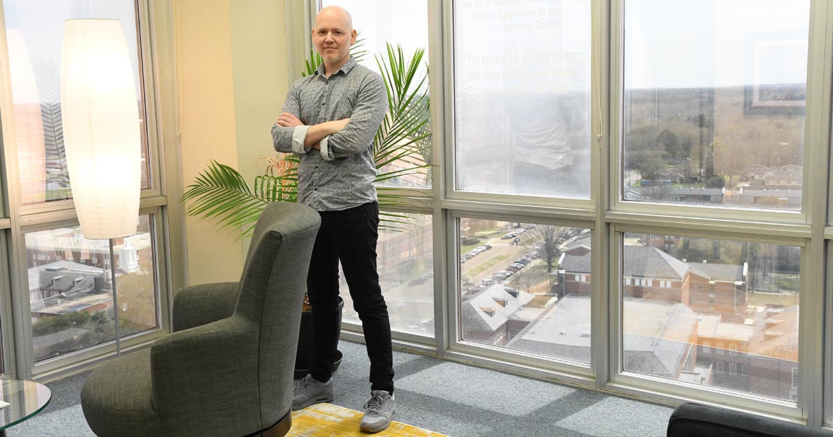 Emerson Oaks standing in Dr. Davy Norris' office in Wyly Tower.