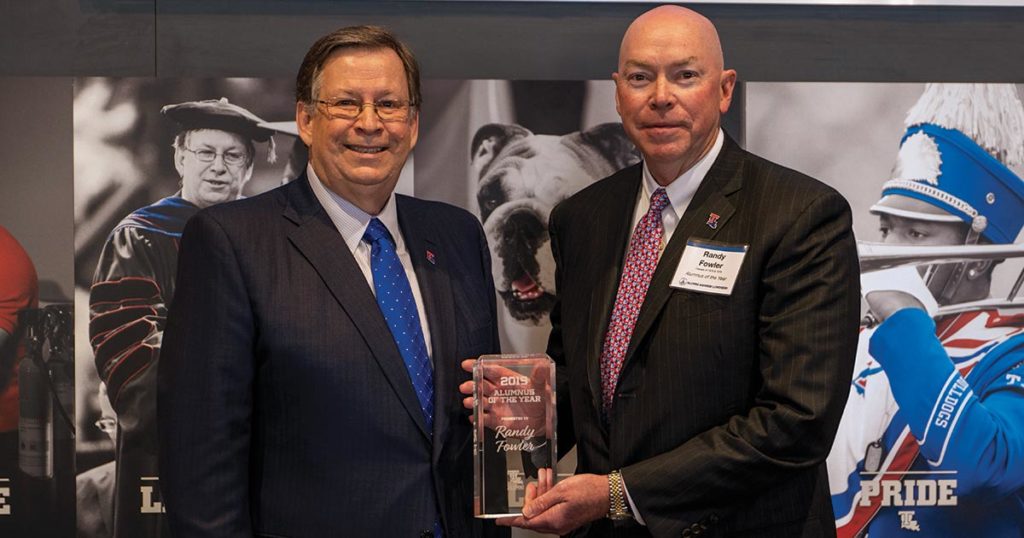 Dr. Guice presenting Randy Fowler with the Distinguished Alumnus of the Year award.