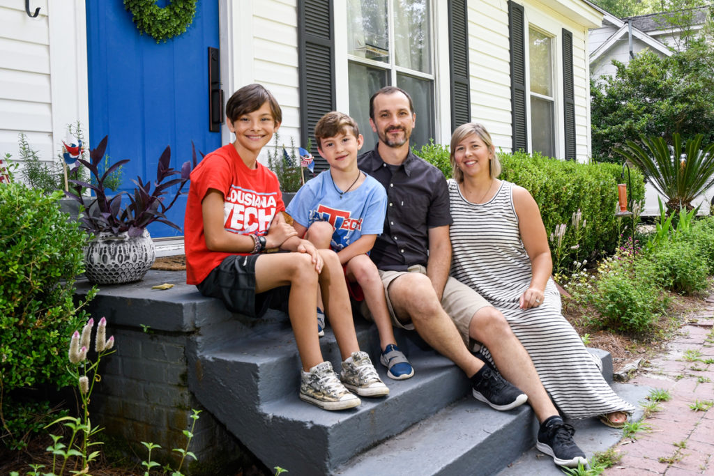 Tech faculty members Lacey and Brad Deal and their sons Finn and Oli hang out in front of their Ruston home.