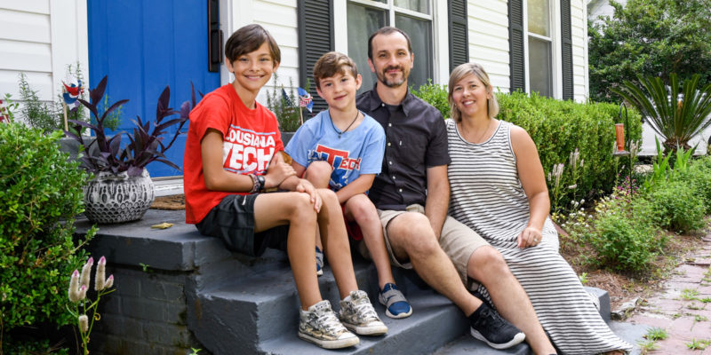 Tech faculty members Lacey and Brad Deal and their sons Finn and Oli hang out in front of their Ruston home.