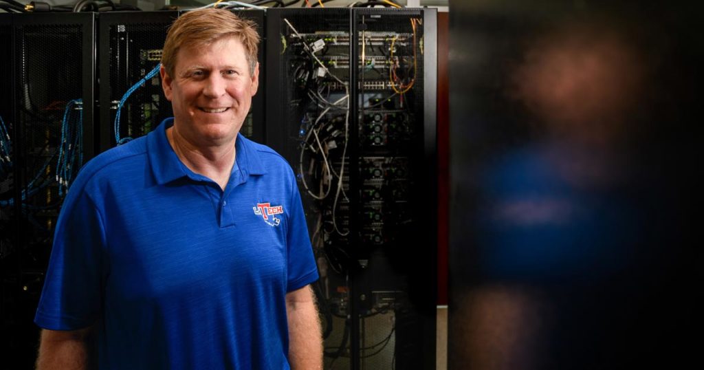 Tom Hoover standing in front of a server at Louisiana Tech.