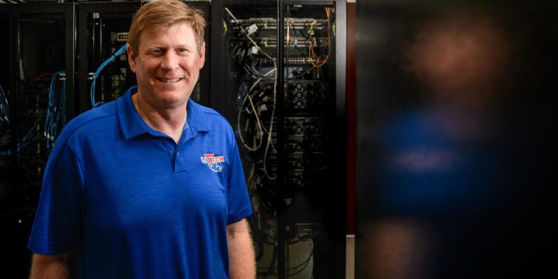 Tom Hoover standing in front of a server at Louisiana Tech.