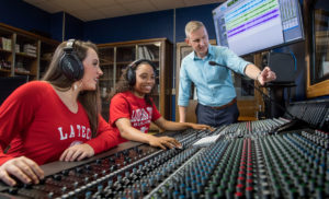 Michael Austin, Founding Director of the School of Music, works with students on a soundboard.