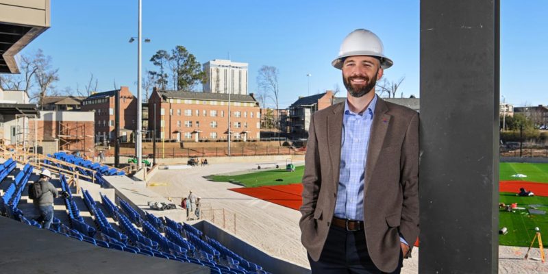 Adam McGuirt poses for a photo from the new baseball facility.