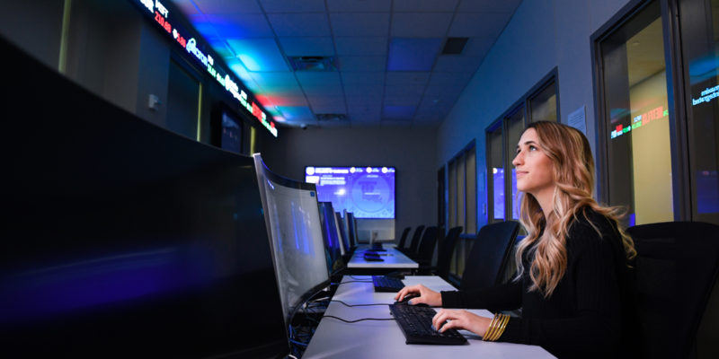 Female student working in Ray's Trading Room.