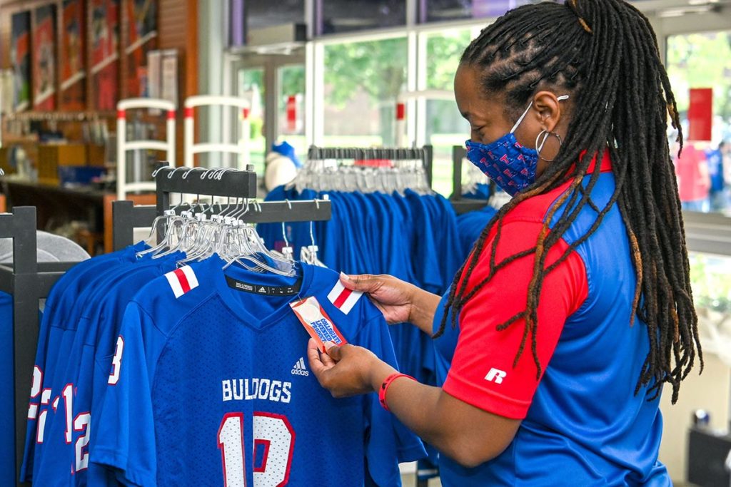 A fan shops for officially licensed apparel at the bookstore.