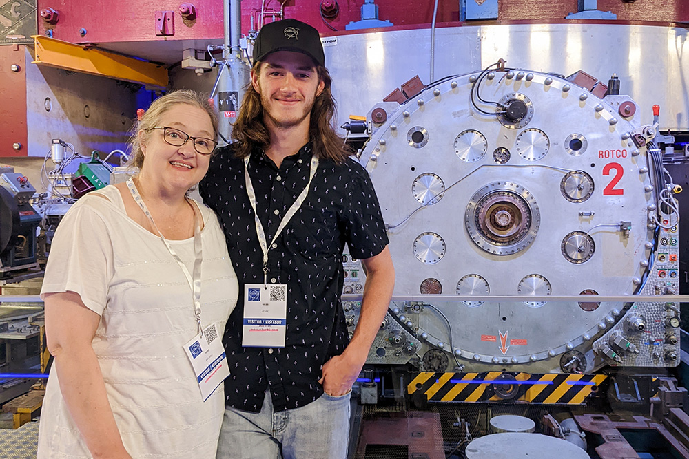 Jesse Webb pictured with his mom in front of CERN‘s first particle accelerator, the synchrocyclotron.