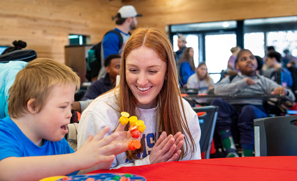Tech nursing student pictured with a MedCamps camper.