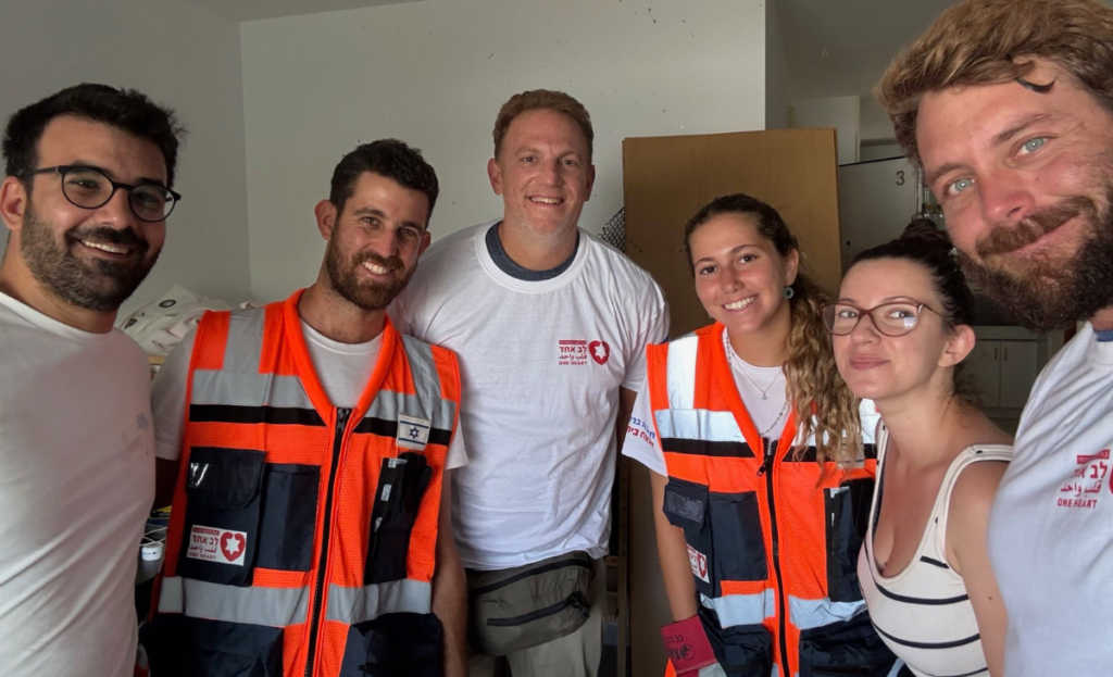 Photo of Griffin with a family he helped in Be'er Sheva who experienced structural damage to their home