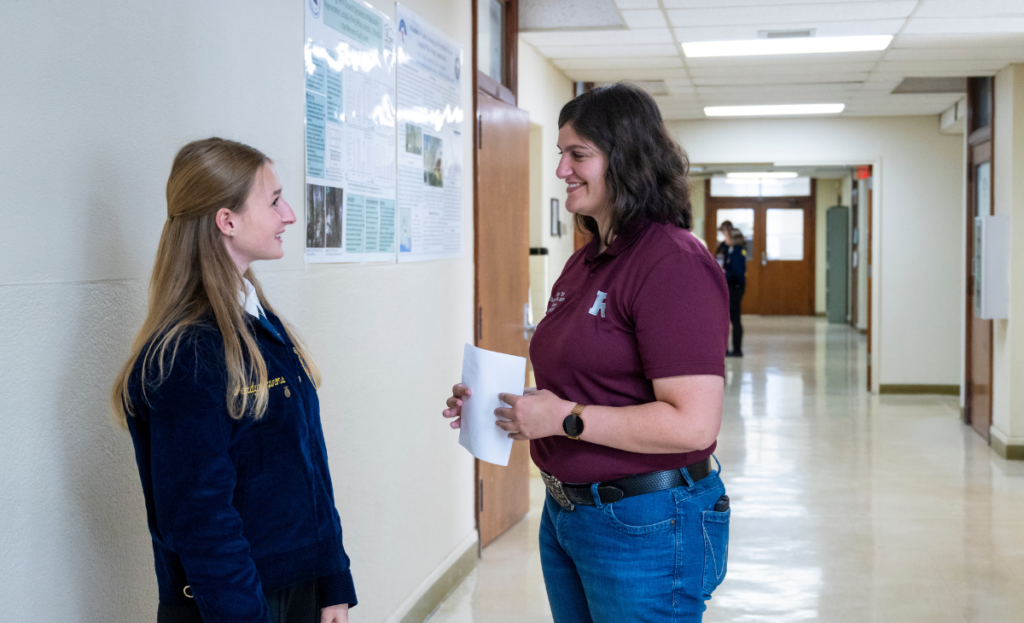 Kylee Triche helping a student before her FFA speech.