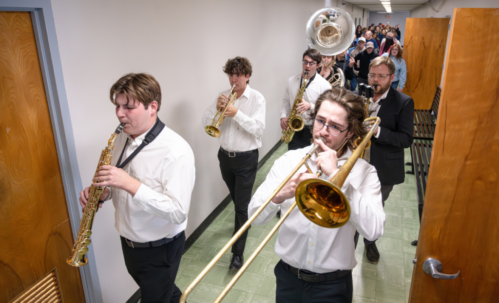 A student-led jazz band leading the parade through the GTM hallways.