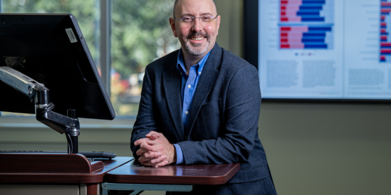 Patrick Scott posing for a photo at the College of Business